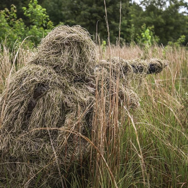 An observer kneeling in a dry field, showcasing the adjustable comfort pants with secure elastic ankles that block out cold drafts and field debris.