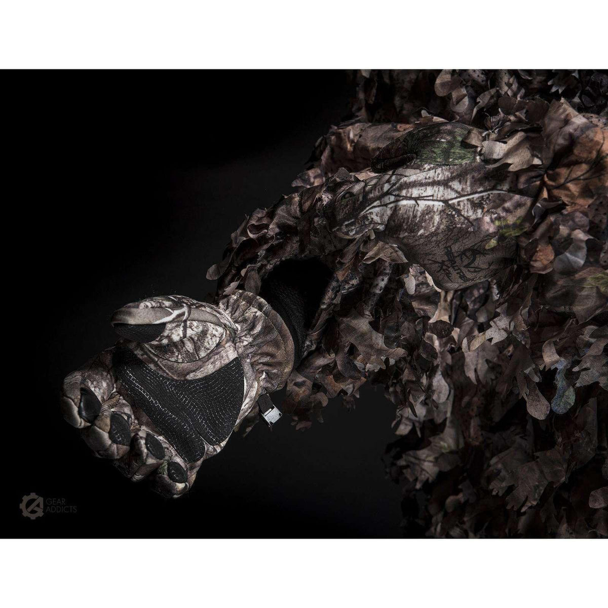 Easy-access zippered front pocket on GhillieLabs leafy suit for retrieving camera accessories in the field
