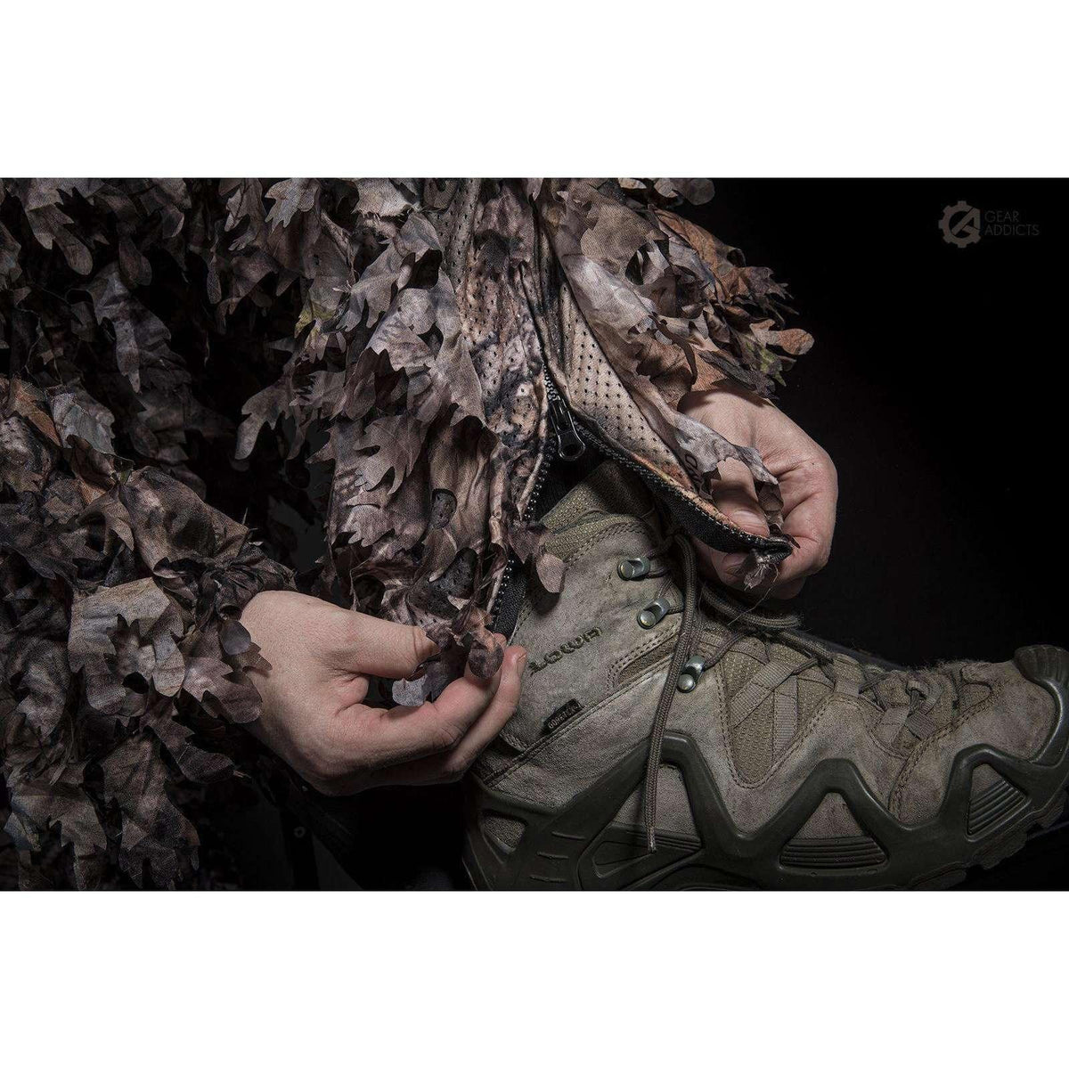 Deep zippered slash pocket on GhillieLabs 3D leafy suit keeping telephoto lens caps and field equipment secure