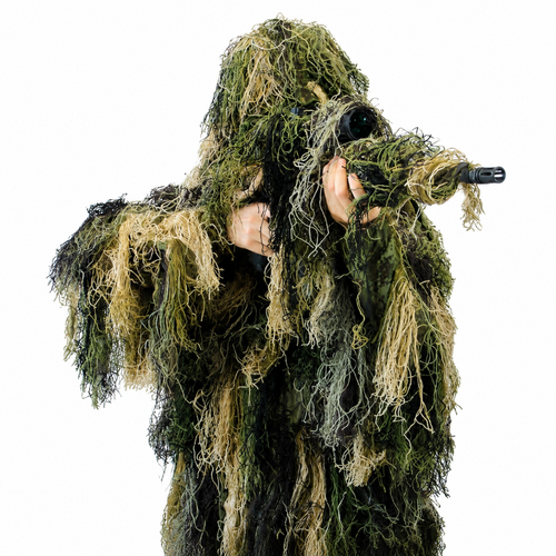 A professional observer wearing GhillieLabs Pro-Series 4-Piece Camouflage System in Woodland Forest pattern, holding a camo-wrapped long-focus telephoto camera lens.