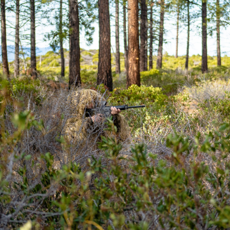 Absolute invisibility achieved by an alpine ecology researcher utilizing over 1,000 feet of dense synthetic jute to blend seamlessly into seasonal forest floor shadows.