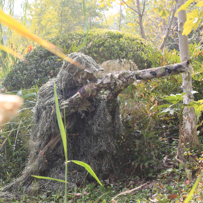 Prone scouting position showing how the Dry Grass Ghillie Poncho traps ambient light to mimic a low earth mound